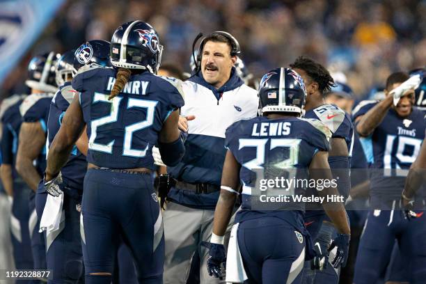 Head Coach Mike Vrabel congratulates Derrick Henry of the Tennessee Titans after scoring a touchdown during the second half of a game against the...