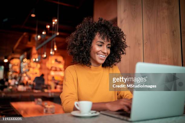 portrait of beautiful woman using a laptop - using laptop stock pictures, royalty-free photos & images