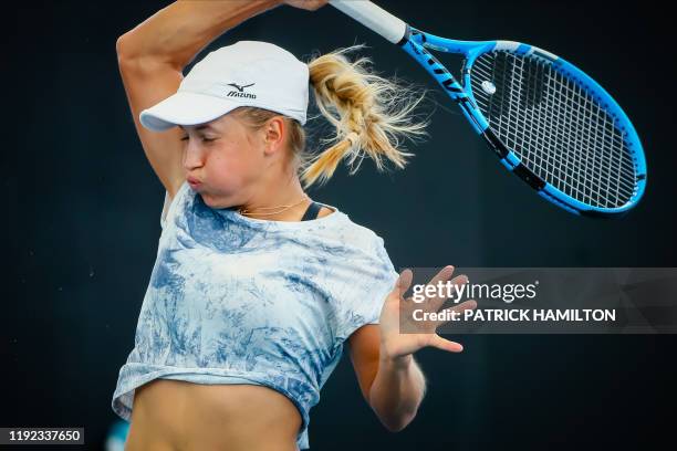 Yulia Putintseva of Kazakhstan hits a return against Donna Vekic of Croatia during the women's singles match on day two of the Brisbane International...