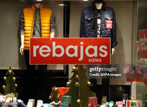 Rebajas sign seen in a shop window indicating the New Years Sales have begun in Spain. With windows still dressed for Christmas, most shops in Spain...