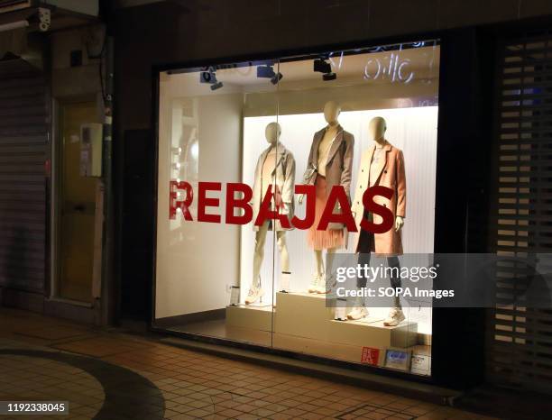 Rebajas sign seen in a shop window indicating the New Years Sales have begun in Spain. With windows still dressed for Christmas, most shops in Spain...