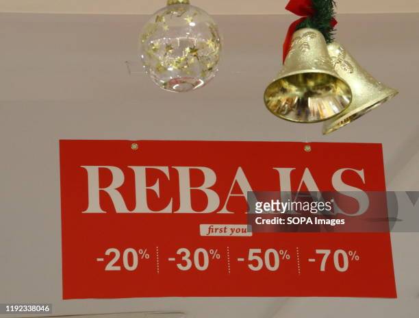 Rebajas sign seen in a shop window indicating the New Years Sales have begun in Spain. With windows still dressed for Christmas, most shops in Spain...