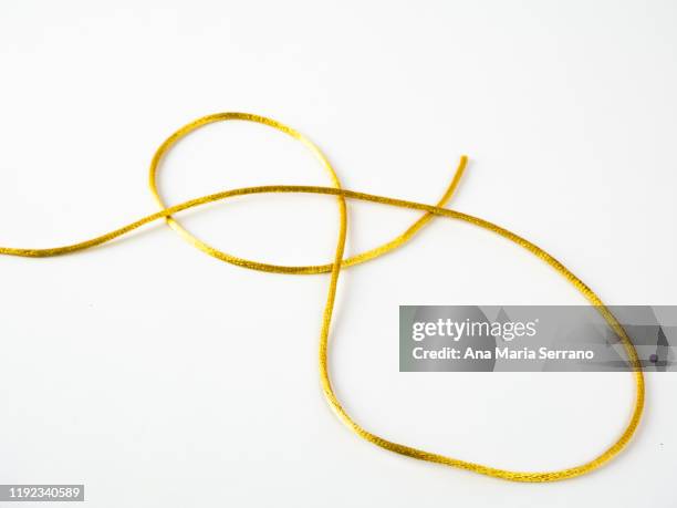 golden silk thread on a white background - wire bonding stock pictures, royalty-free photos & images