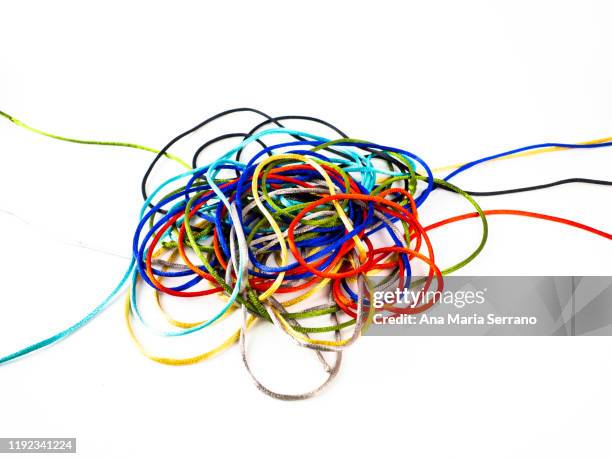abstract background of brightly colored silk threads intertwined on a white background - tied knot stock pictures, royalty-free photos & images