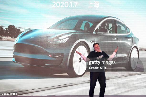 Tesla CEO Elon Musk gestures during the Tesla China-made Model 3 Delivery Ceremony in Shanghai. Tesla CEO Elon Musk presented the first batch of...