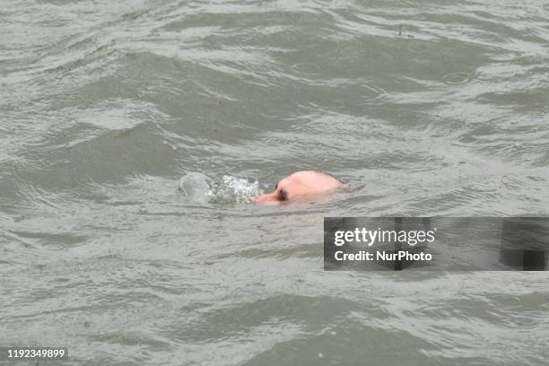 Maritime police help an Orthodox faithful who deteriorates after diving into icy waters during the Orthodox Epiphany Day marking the anniversary of...