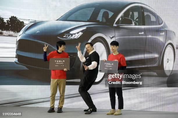 Elon Musk, chief executive officer of Tesla Inc., gestures during the Tesla China-Made Model 3 Delivery Ceremony at the company's Gigafactory in...