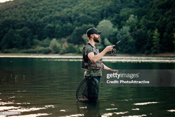 young man fishing - young men fishing stock pictures, royalty-free photos & images