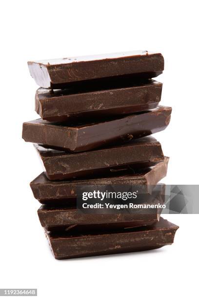 stack of chocolate pieces on white background - chocolate pieces stock-fotos und bilder