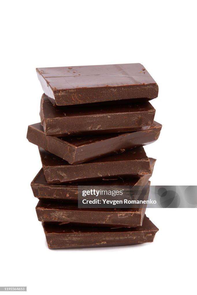 Stack of chocolate pieces on white background