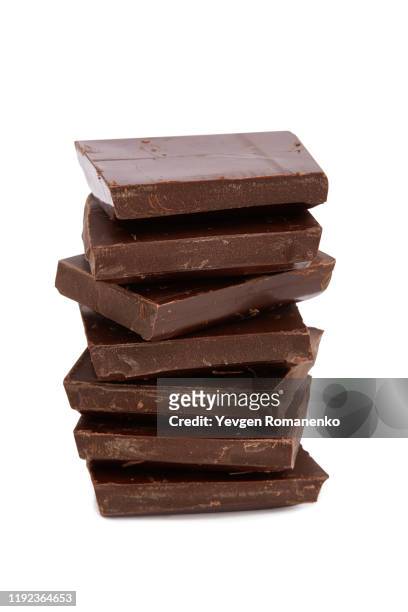stack of chocolate pieces on white background - dark chocolate on white stock pictures, royalty-free photos & images