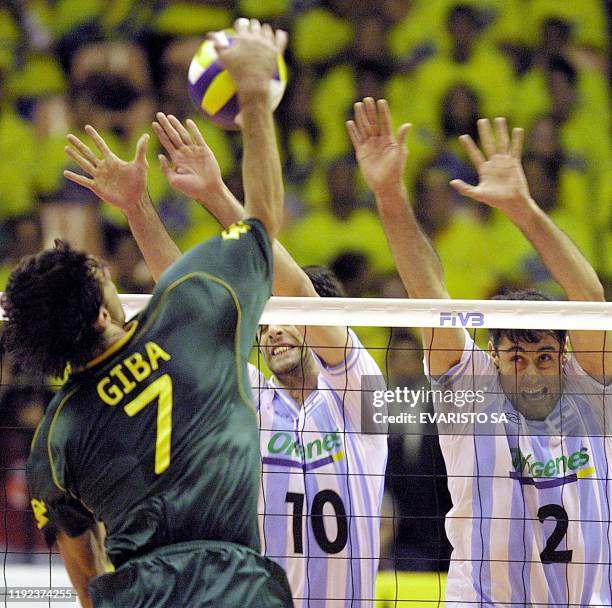 Players of the Argentinian Volleyball Team Jorge Elgueta and Alejandro Spajic , try to block the ball from the brazilian Giba, during a match for the...