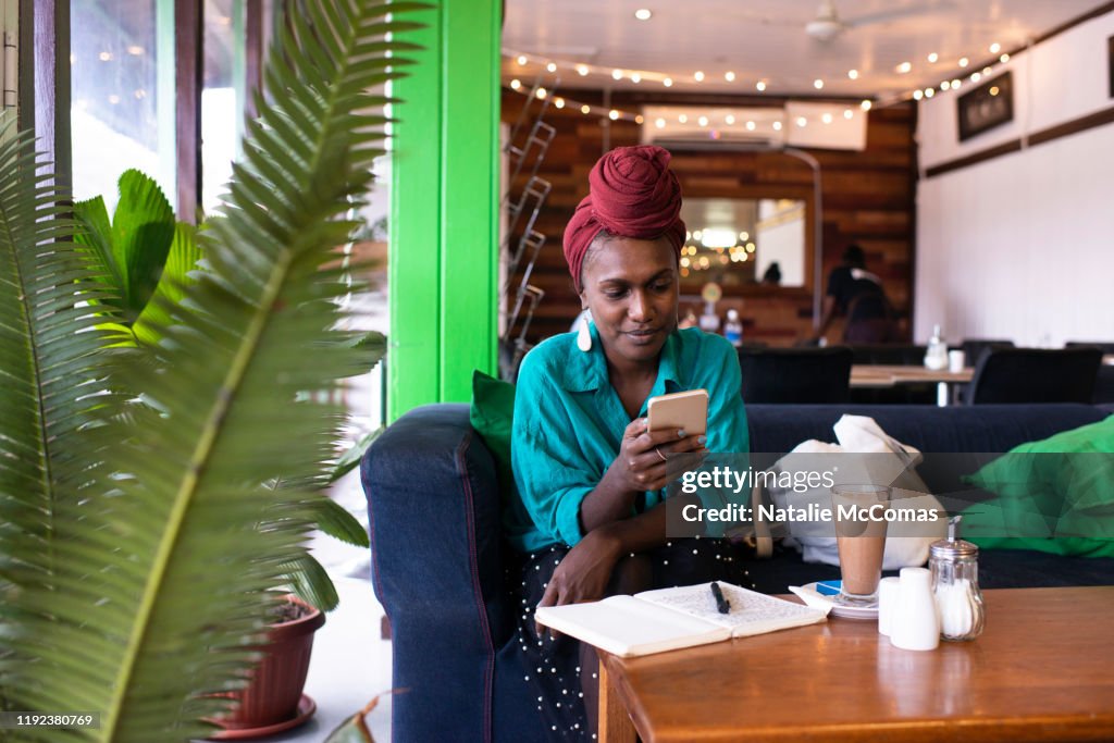 Daytime Phone Example One Young Woman Using Mobile Phone At A Cafe In The Daytime High-Res ...