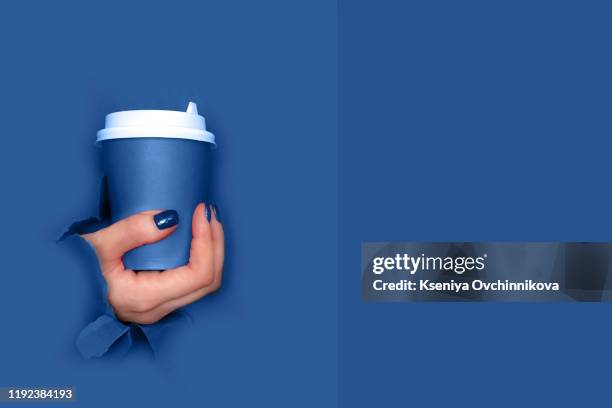 young woman drinking coffee from disposable cup - blue cup stock pictures, royalty-free photos & images