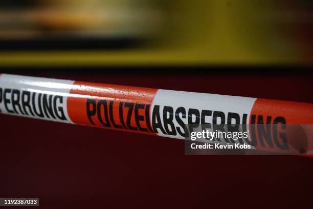 barrier tape of the german police with rain drops at a train station in berlin, germany. - absperrband stock-fotos und bilder