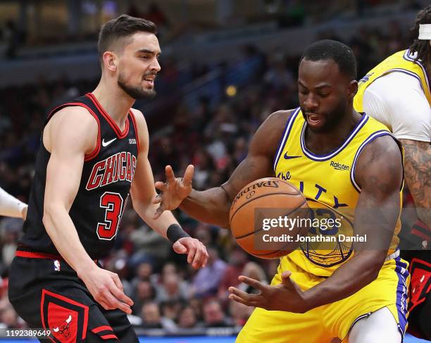 Draymond Green of the Golden State Warriors knocks the ball away from Tomas Satoransky of the Chicago Bulls at United Center on December 06, 2019 in...