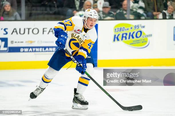 Saskatoon Blades defenseman Charlie Wright passes the puck in the neutral zone during the first period of a game between the Everett Silvertips and...