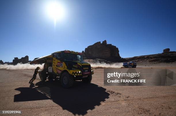 Czech Republic's truck driver Martin Macik, co-drivers Frantisek Tomasek and David Svanda change tyre during the Stage 3 of the Dakar 2020 around...