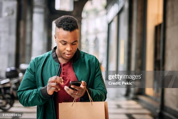 man checking shopping list on his smart phone for christmas gifts - christmas background no people stock pictures, royalty-free photos & images