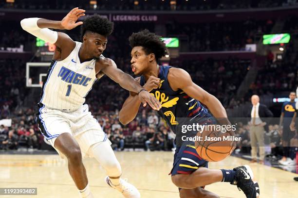 Collin Sexton of the Cleveland Cavaliers drives around Jonathan Isaac of the Orlando Magic during the second half at Rocket Mortgage Fieldhouse on...