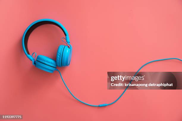 headphones on the pink background - white hat fashion item stock-fotos und bilder