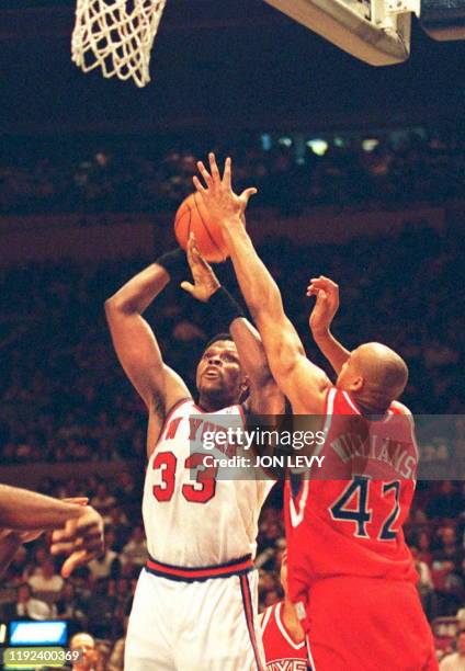 New York Knicks Patrick Ewing lines up a shot with Philadelphia 76ers Scott Williams attempting the block during the first half of their NBA game 10...