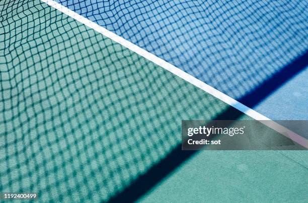 side lines of the tennis court with tennis net shadow - tennis net stock pictures, royalty-free photos & images