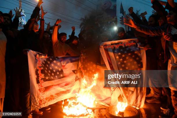 Pakistani Shiite Muslim burn US and Israeli flags in a protest against the killing of top Iranian commander Qasem Soleimani in the US strike in Iraq,...