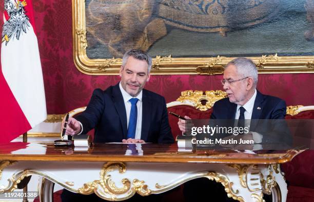 Interior Minister Karl Nehammer and Federal President Alexander van der Bellen speak during the swearing-in ceremony of the new Austrian government...