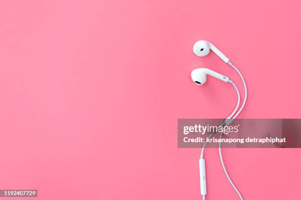 headphones on pink backgrounds. - red telephone box stock-fotos und bilder