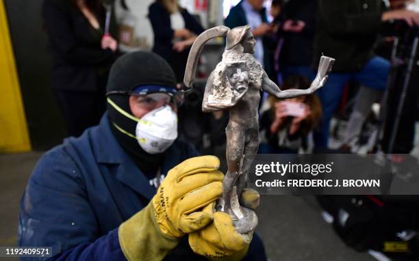 Welder Servando Santamaria displays the statue of the Screen Actors Guild Award known as 'the Actor' after breaking the mould at the American Fine...