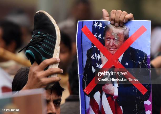 Placard of US President Doland Trump is seen during a protest against the killing of Iranian major general Qassim Soleimani, near US high commission...