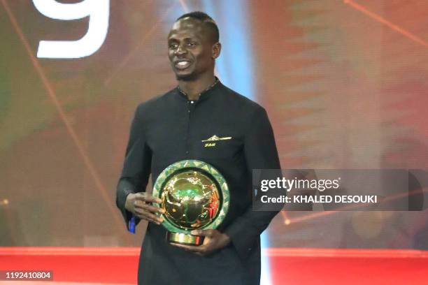 Senegal winger Sadio Mane smiles after winning the Player of the Year award during the 2019 CAF Awards in the Egyptian resort town of Hurghada on...