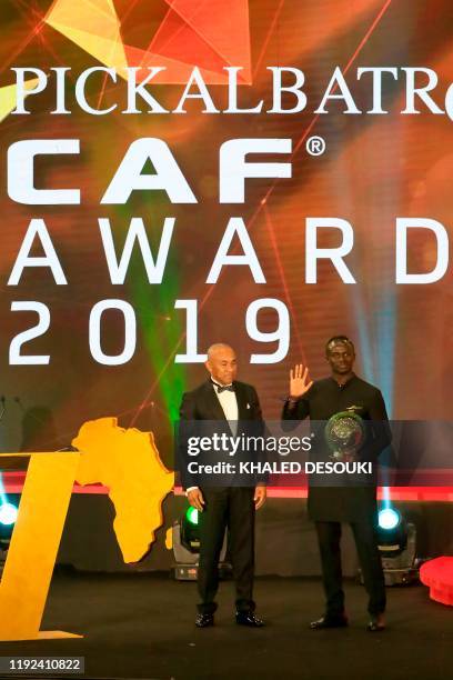Senegal winger Sadio Mane receives the award for Player of the Year from Ahmad Ahmad, President of the Confederation of African Football, during the...