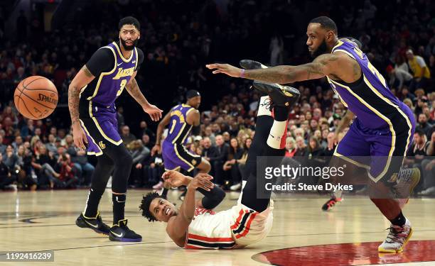 Hassan Whiteside of the Portland Trail Blazers is knocked to the floor as Anthony Davis and LeBron James of the Los Angeles Lakers go after the ball...