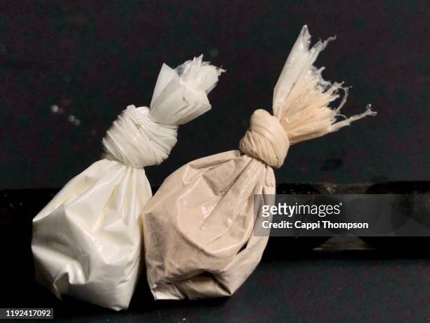 cocaine and heroin in bags with stem in background - methamphetamine stock pictures, royalty-free photos & images