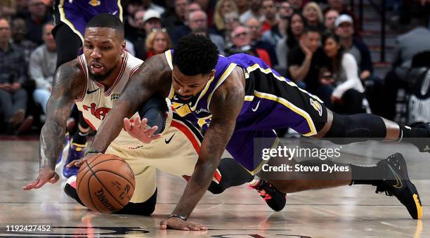 Damian Lillard of the Portland Trail Blazers and Troy Daniels of the Los Angeles Lakers go after a loose ball during the second half of the game at...