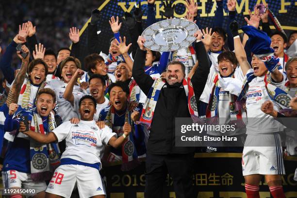 Players of Yokohama F.Marinos celebrate as their head coach Ange Postecoglou lifts the trophy after the J.League J1 match between Yokohama F.Marinos...