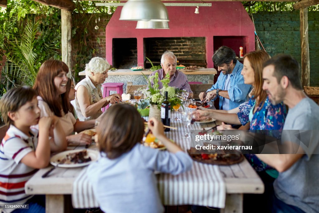 Argentine Family Enjoying Traditional Asado Midday Meal