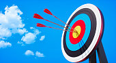 Archery target and arrow on blue sky