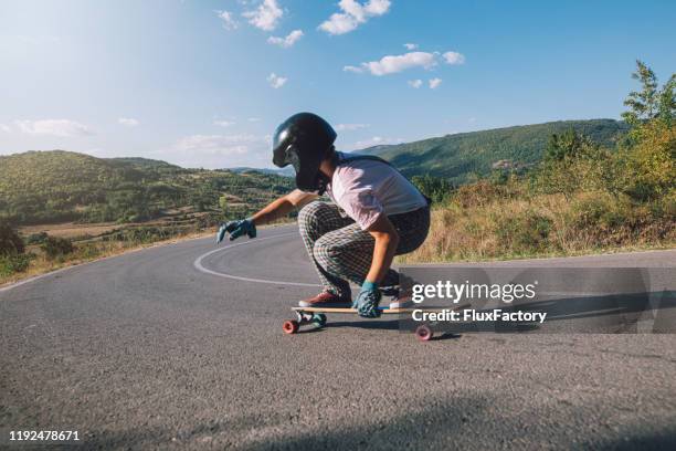 adventuring longboarder riding on a sunny day - longboard surfing stock pictures, royalty-free photos & images