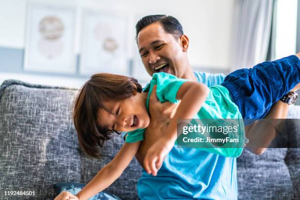 asian muslim dad and son enjoying family time - malay archipelago stock pictures, royalty-free photos & images