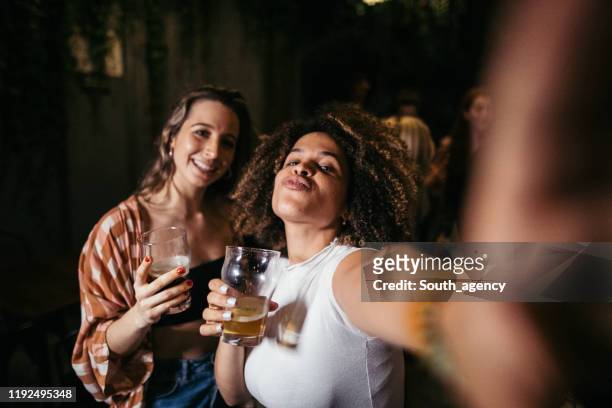 friends taking selfie in pub - an unforgettable evening stock pictures, royalty-free photos & images