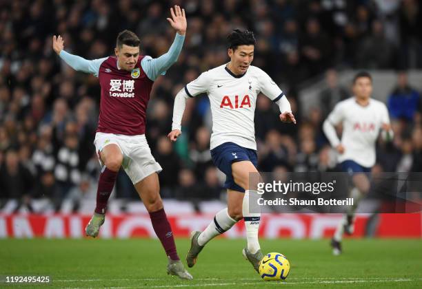 Heung-Min Son of Tottenham Hotspur runs with the ball on his way to scoring his team's third goal during the Premier League match between Tottenham...