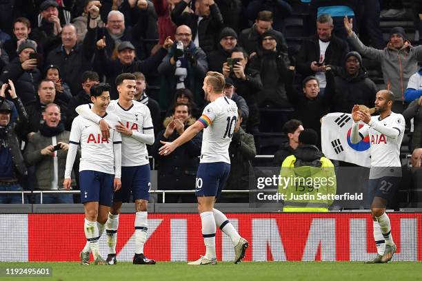 Heung-Min Son of Tottenham Hotspur celebrates after scoring his team's third goal with Dele Alli and Harry Kane during the Premier League match...