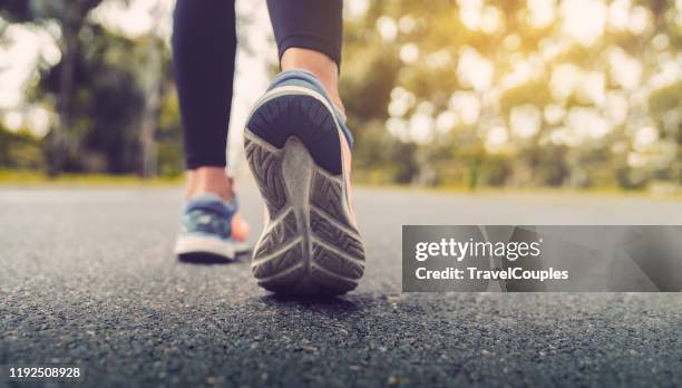 woman feet running on road closeup on shoe. young fitness women runner legs ready for run on the road. sports healthy lifestyle concept. - running shoe fotografías e imágenes de stock