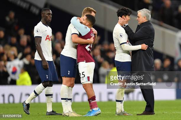 Jose Mourinho, Manager of Tottenham Hotspur embraces Heung-Min Son of Tottenham Hotspur following victory as Harry Kane of Tottenham Hotspur embraces...