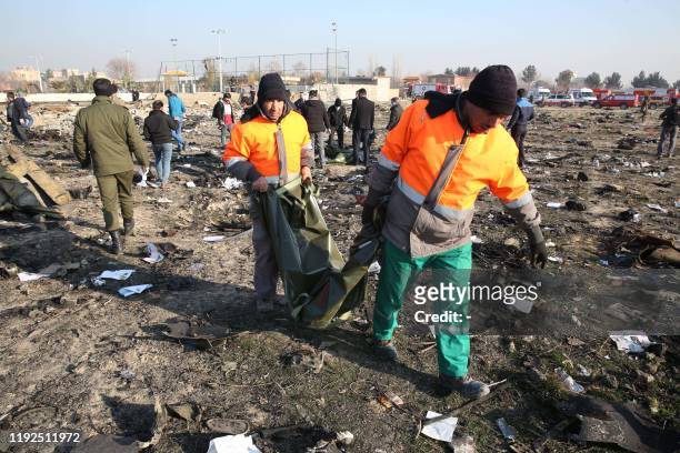 Rescue teams work at the scene after a Ukrainian plane carrying 176 passengers crashed near Imam Khomeini airport in the Iranian capital Tehran early...