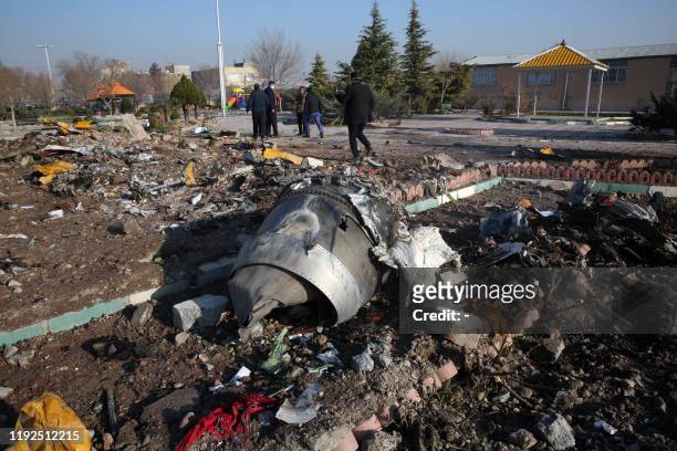 Rescue teams work amidst debris after a Ukrainian plane carrying 176 passengers crashed near Imam Khomeini airport in the Iranian capital Tehran...