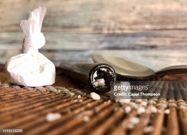crack cocaine, bag of powdered cocaine, and crack stem - crack cocaine fotografías e imágenes de stock